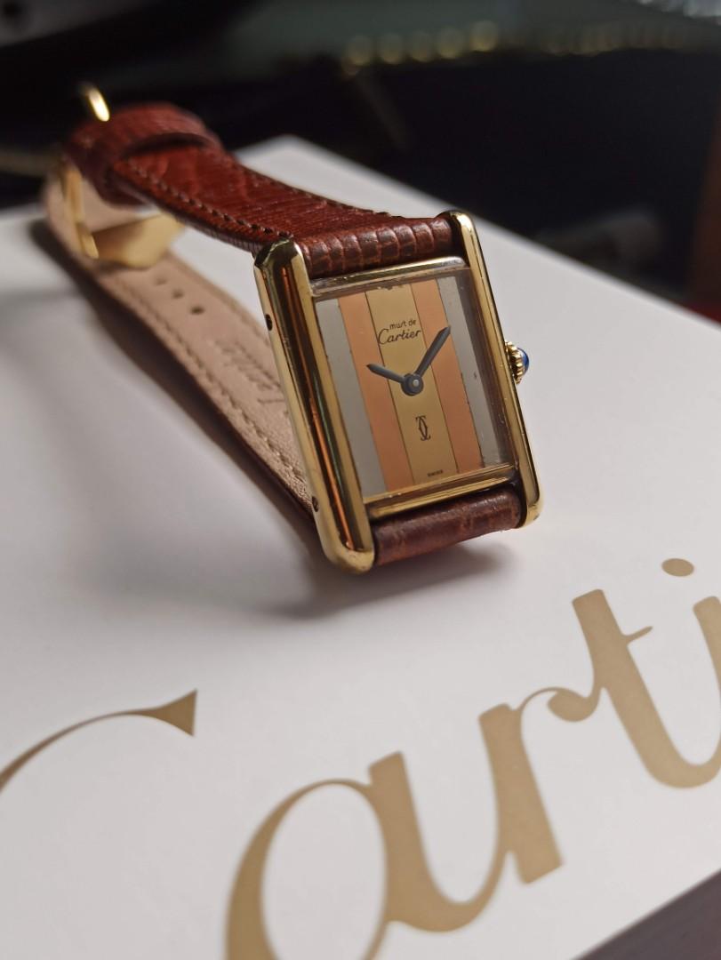 Cartier Tank Must De Cartier Trilogy dial 1980 model Silver PVD Gold accents Quartz movement Luxury timepiece Vintage watch Sterling silver case Yellow gold coating Brown leather strap Elegant design Classic watch High-quality craftsmanship Timeless style Beat The Waitlist Watch accessories Watch box Presentation papers Collector's item